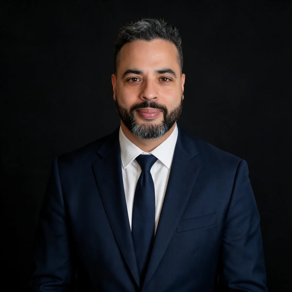 Nicholas Aponte-Rodriguez, founder of ASEC Services, in a navy suit